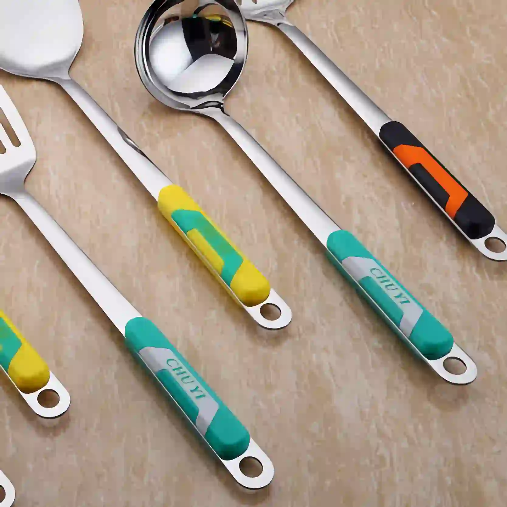 The plastic handles of the stainless steel kitchen utensils