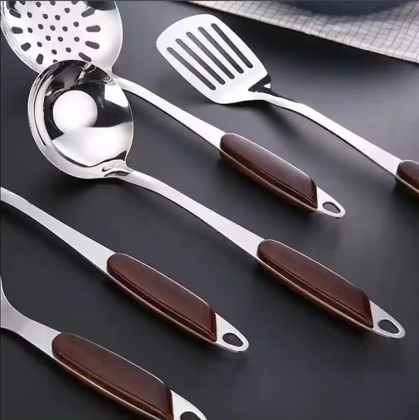 The wooden handles of the stainless steel kitchen utensil sets