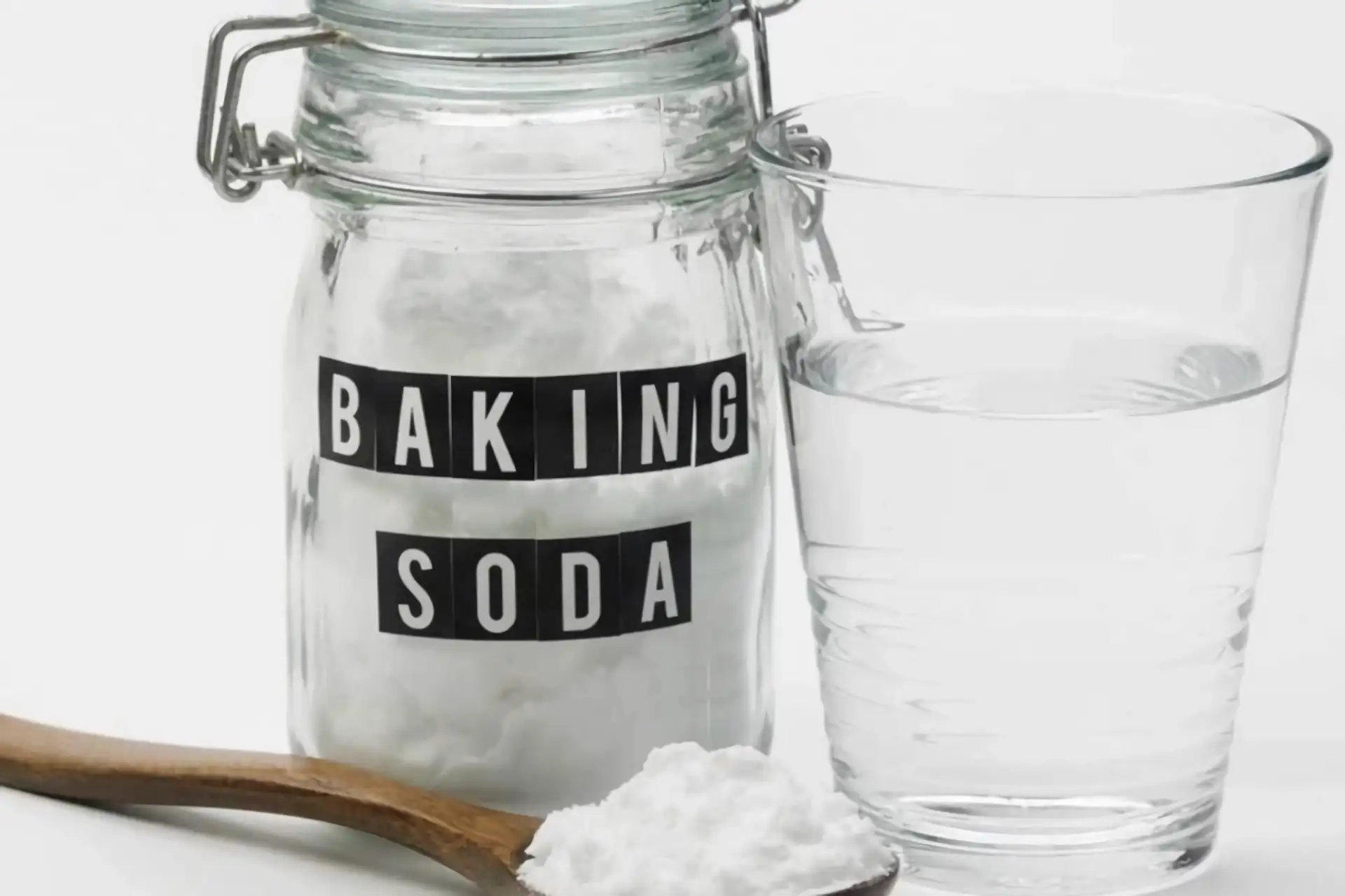 A bottle of baking soda and a glass of water