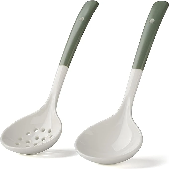 Ceramic cooking utensils with green handle against white background