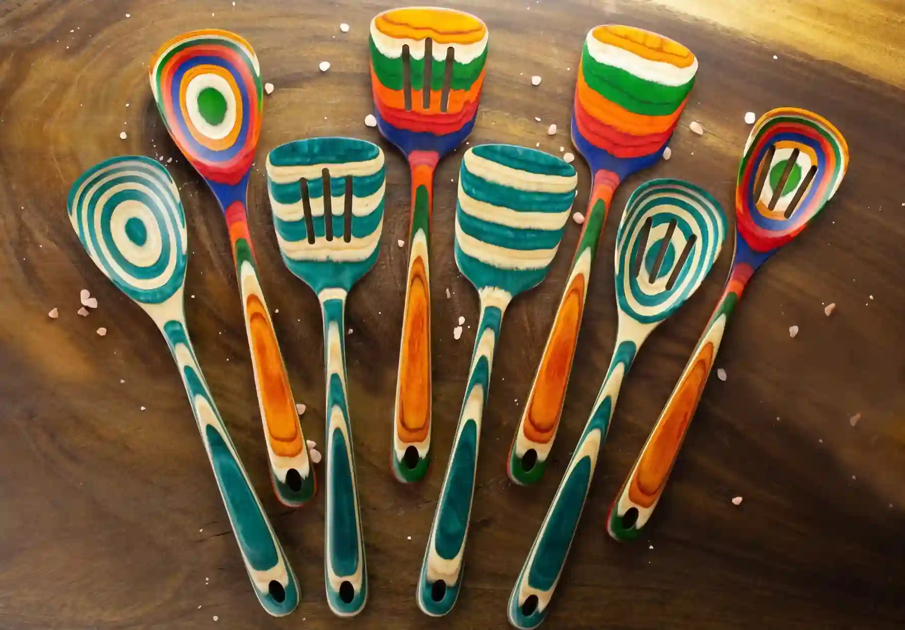 Colored birch utensils sitting on wooden tabletop