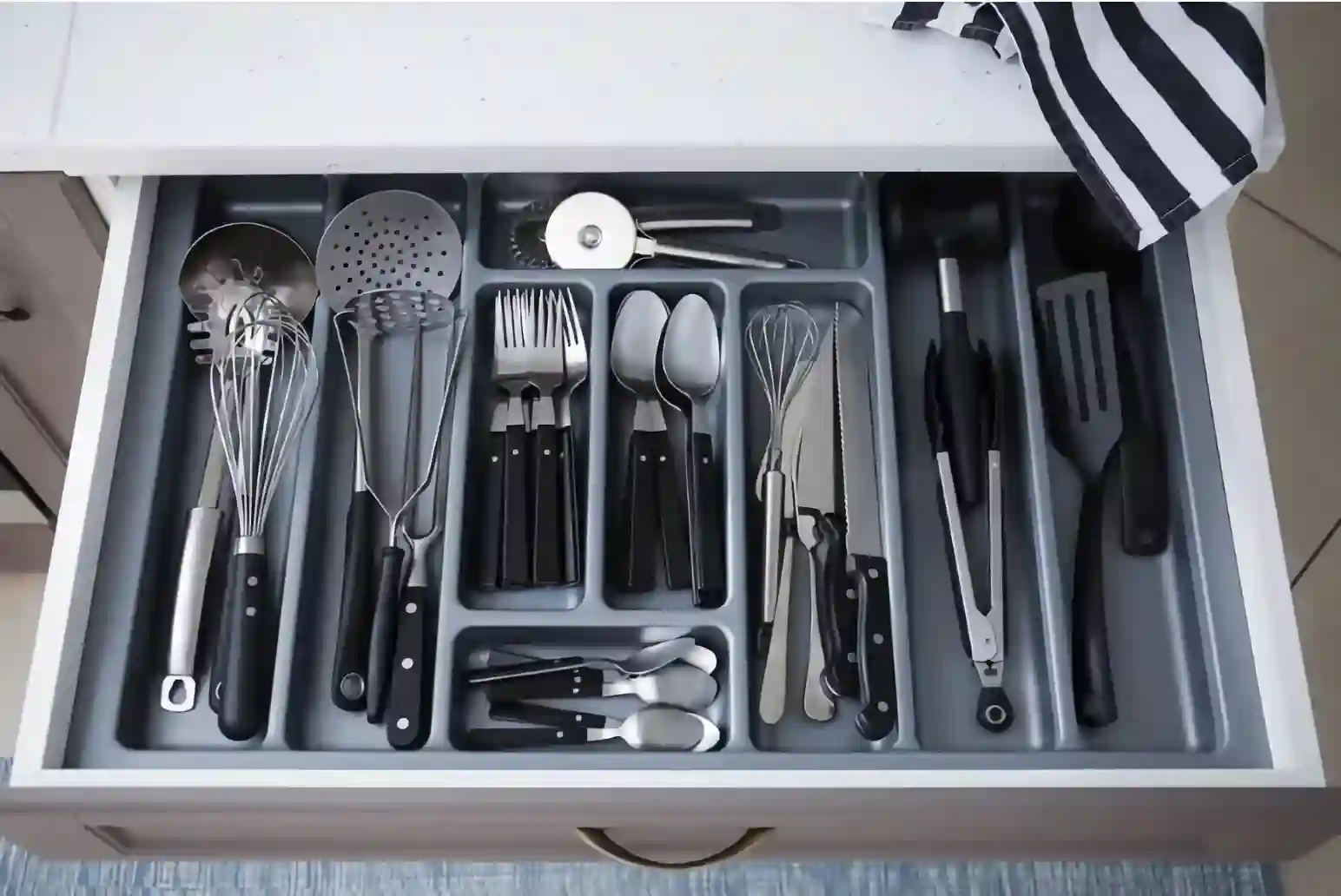 Utensils in drawer compartmentalized tray