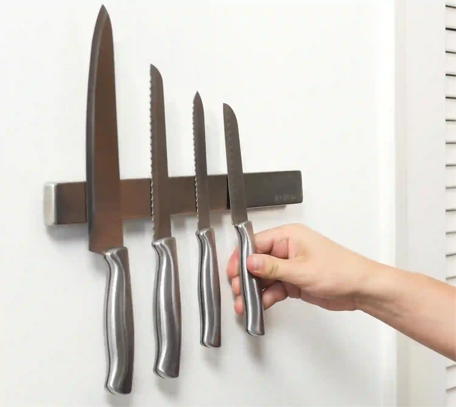 Magnetic knife holder filled with knifives