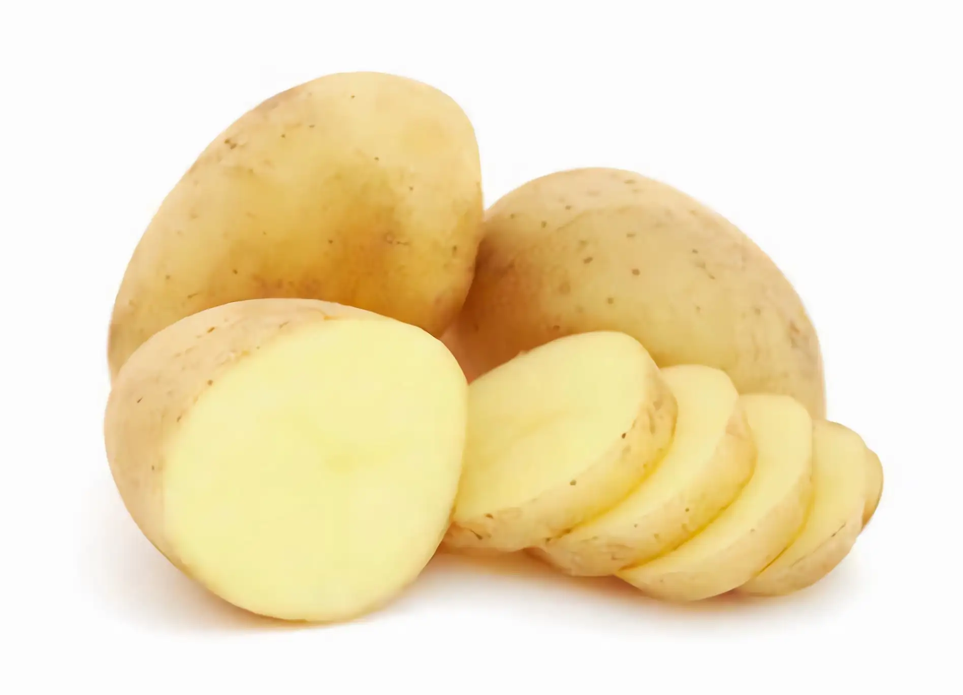 Whole potatoes and potato sliced against white background