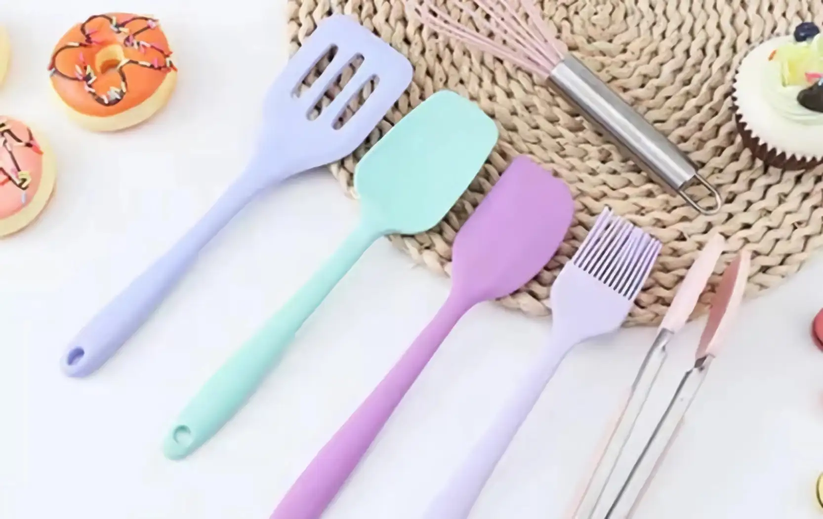 Silicone cooking kitchen accessories set are placed on the white countertop