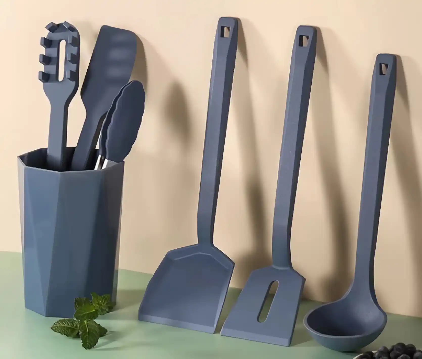 3 pieces silicone cooking utensils on the utensil crock and 3 pieces on the wall
