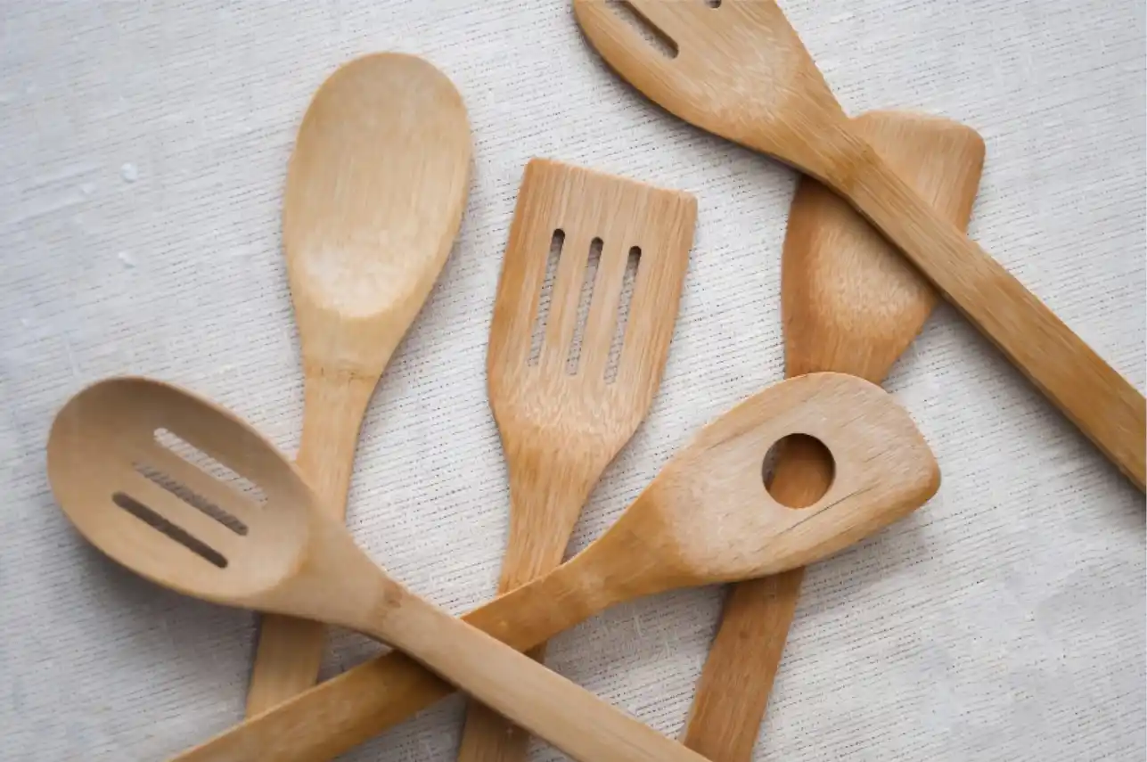 A pile of wooden utensils sitting on top of a table